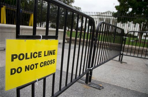 In this Oct. 3, 2014, file photo, a temporary barrier marked with a sign "Police Line Do Not Cross" is seen along Pennsylvania Avenue in front of the White House in Washington. The Secret Service has placed a high-ranking supervisor on administrative leave and suspended the supervisor's security clearance after what it calls "allegations of misconduct and potential criminal activity." (AP Photo/Carolyn Kaster, File)