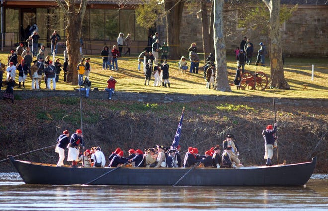 WASHINGTON CROSSING, PA - DECEMBER 7: Re-enactors row a boat during a dress rehearsal for the crossing of the Delaware River at Washington Crossing State Park December 7, 2014 in Washington Crossing, Pennsylvania. The dress rehearsal is held annually, about two weeks before the Christmas Day reenactment. (Photo by William Thomas Cain/Cain Images)