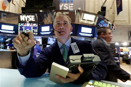 Trader Timothy Nick works on the floor of the New York Stock Exchange, Monday, April 20, 2015. U.S. stocks are opening higher as more big companies turn in healthy financial results for the first quarter of the year. (AP Photo/Richard Drew)