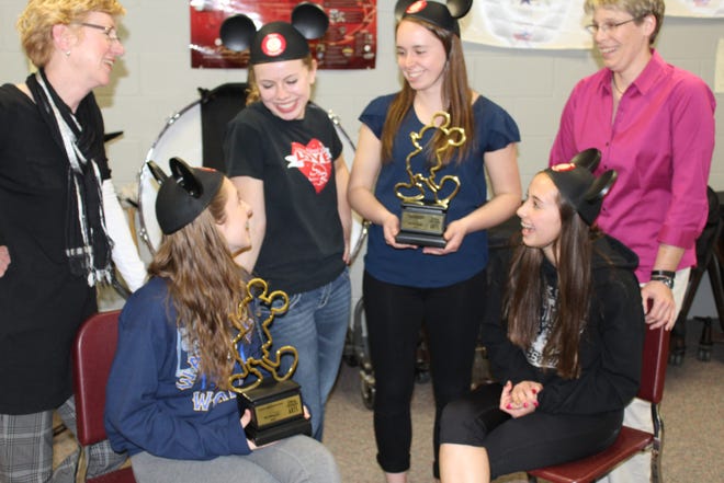 Jennifer Fox, Dakota choir director (standing, left), and Annette Hackbarth, marching band director (standing, right), recall their Disney experience Thursday, April 16, 2015, with students (left to right) Bryn Schiffman, Rachel Bicksler, Vanessa Vincent and Jessica Vincent.

CINDY SCOTT DAY/THE JOURNAL-STANDARD