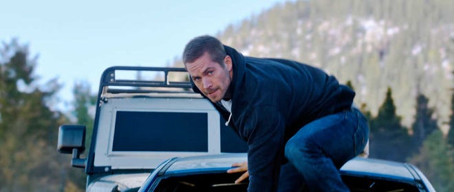 This photo provided by Universal Pictures shows Paul Walker as Brian in a scene from "Furious 7." When the high-speed action sequel "Furious 7" debuts this weekend, audiences at Hollywood's famous TCL Chinese Theatre will see every tire skid and fist fight in Imax's brand-new laser format. (AP Photo/Universal Pictures)