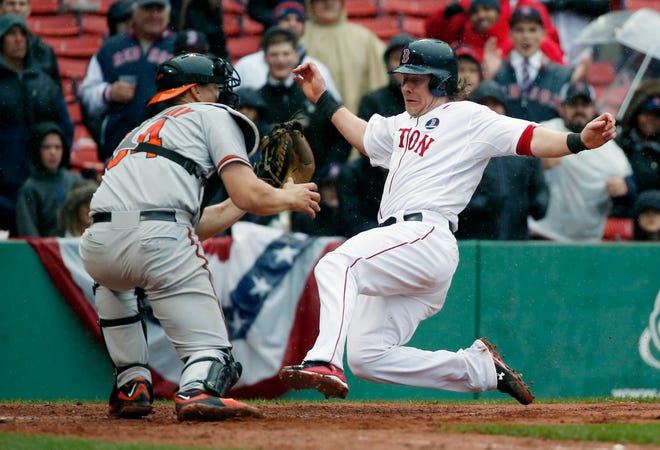 Boston's Ryan Hanigan, right, scores as Baltimore's Ryan Lavarnway waits for the throw on a double by Dustin Pedroia.