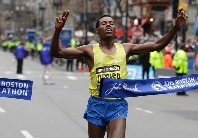 Ethiopia's Lelisa Desisa crosses the finish line to win the men's division of the Boston Marathon.