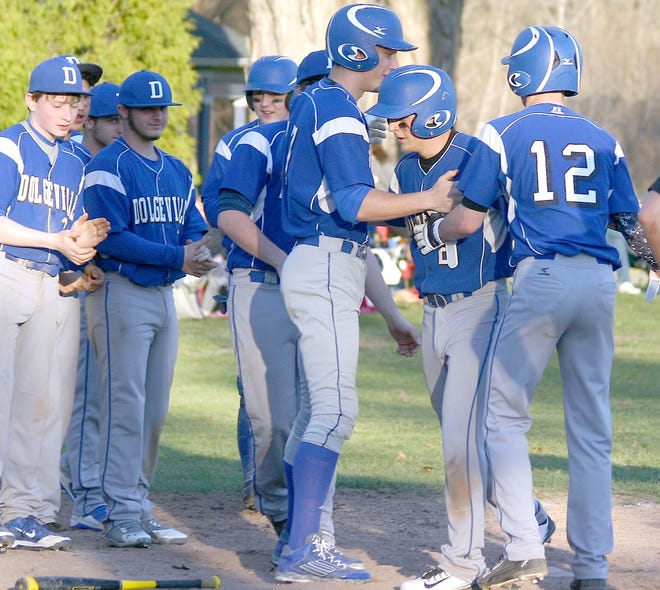 Teammates Johann Doerrer and Reid Johnson (12) greet Dan Fox at home plate after the Ben Conte Memorial Tournament most valuable player homered for Dolgeville Saturday against West Canada Valley. 



Times Photo/Jon Rathbun