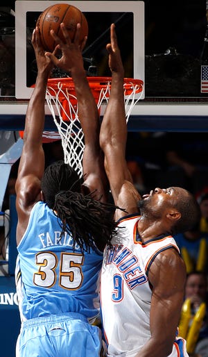 Oklahoma City's Serge Ibaka (9) defends against Denver's Kenneth Faried (35) during the NBA game between the Oklahoma City Thunder and the Denver Nuggets at Chesapeake Energy Arena in Oklahoma City, Sunday, Feb. 22, 2015. [Photo by Sarah Phipps, The Oklahoman Archives]