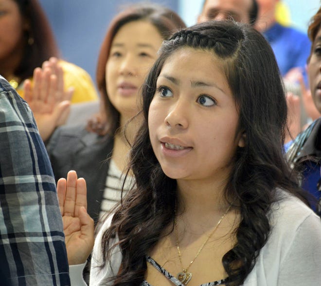 Yazmin Var Rodriguez repeats the oath to become a naturalized U.S. citizen on Wednesday.