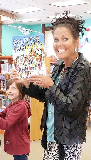 Loveberry shows off her book, "Splatter Paint Hero." Cherith Nottingham photo
