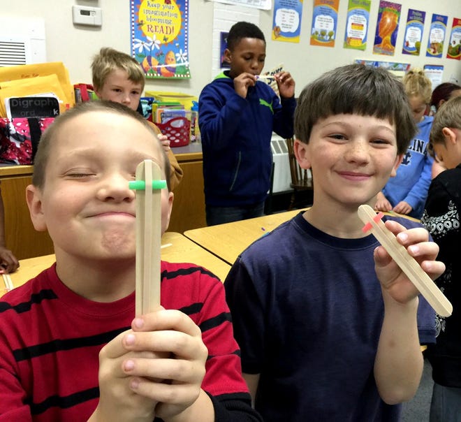 Washington fourth-graders show their instruments.