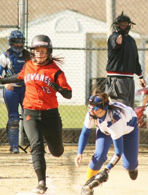 Kewanee’s Carson Mallery (12) is safe at first base as an errant throw gets past Galva’s Rachel VanDeVelde. The Lady Wildcats cracked three home runs in their 26-6 win over the Boiler Girls Wednesday.