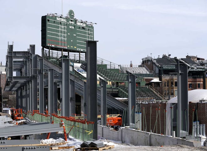FILE - In this March, 2015, file photo, construction of the left field bleachers and new video board continues while the Chicago Cubs' press forward on renovations to Wrigley Field as opening day approaches in Chicago. A lawyer for rooftop clubs overlooking Wrigley Field told a federal court Monday that if the Chicago Cubs are permitted to erect a giant video board blocking views of games from across the street it would kill their lucrative business. (AP Photo/Charles Rex Arbogast, File)
