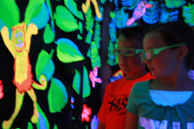 Second-grade students Austin Bouchard and Ali Bierwagen admire the 3D art they created at Freedom Elementary School.