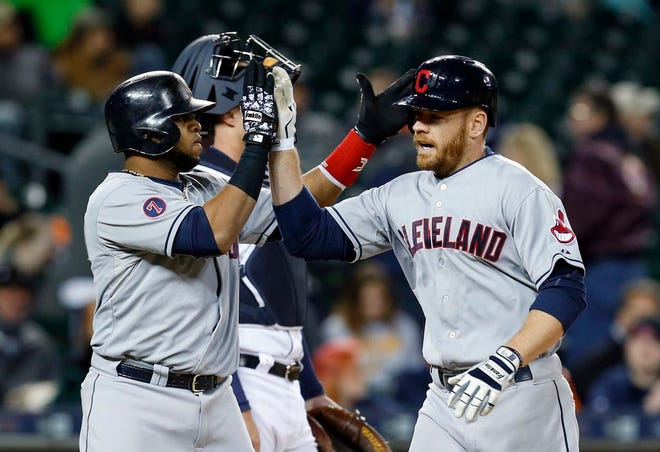 Cleveland Indians' Brandon Moss, right, celebrates his two-run home run with teammate Carlos Santana in the ninth inning of Friday's game in Detroit.