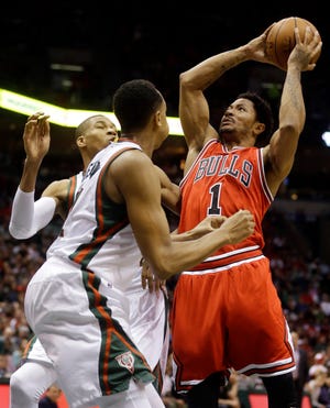 Chicago Bulls' Derrick Rose shoots against Milwaukee Bucks' John Henson and Giannis Antetokounmpo during the first half of Game 4 of a first-round playoff series Saturday in Milwaukee. (AP Photo/Morry Gash)