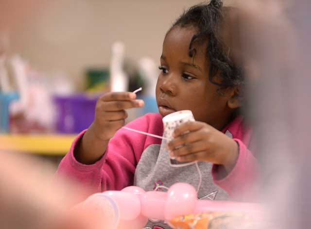 Iyana Best, 5, works on a craft at Southeast Elementary School in Kinston during the KICK-II event on Saturday, organized by the Kinston Department of Public Safety.