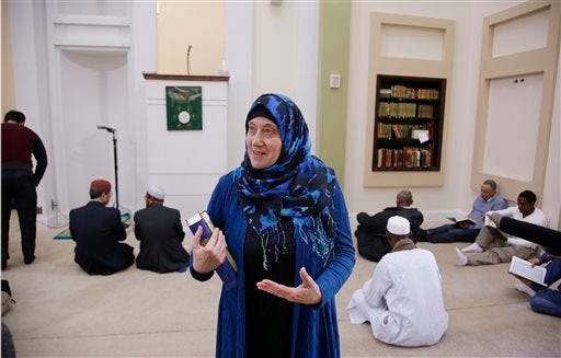 Barbara Schli conducts a tour of the mosque at the Islamic Society of Boston Cultural Center during an open house themed "Still Boston Strong" before "a call to prayers" Friday, April 24, 2015, in Boston. Organizers stressed that Dzhokhar and Tamerlan Tsarnaev and other convicted terrorists are not representative of their faith communities.(AP Photo/Stephan Savoia)
