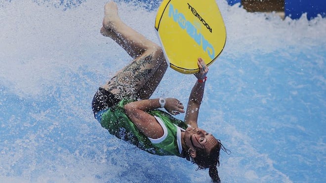 Dee Spencer performs a high-end maneuver during the third annual FLOW Tour Pro Am event at Rapids Water Park in Riviera Beach on Saturday. (Damon Higgins / The Palm Beach Post)