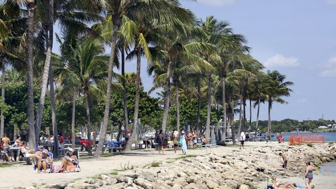 Visitors to DuBois Park enjoy the beach on the north side of the park Apr 25, 2015, in Jupiter. (Bill Ingram / Palm Beach Post)