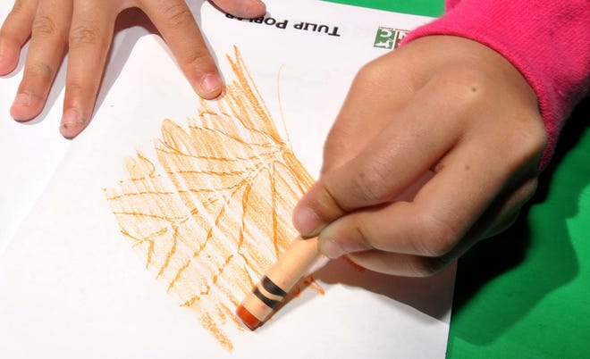 Livia Kam, 7, of Westampton, draws tree leaves during the 2015 Arbor Day Festival at Rancocas Nature Center in Westampton on Sunday.