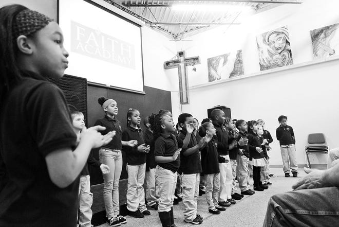 David Scrivner/Associated Press Students at Faith Academy sing to guests at their school March 31 in Iowa City. The academy, which is in its second academic year after opening in the fall of 2013, has three classes of about 10 students each in kindergarten through second grade.