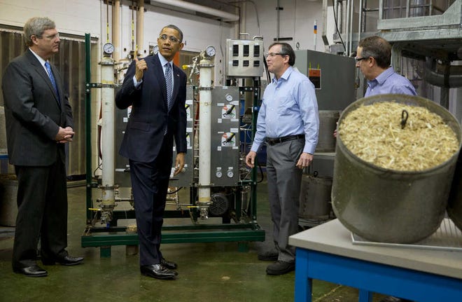 Agriculture Secretary Tom Vilsack, left, and President Barack Obama tour the biomass conversion process area at Michigan State University in East Lansing where Obama signed the sweeping farm bill into law last year.