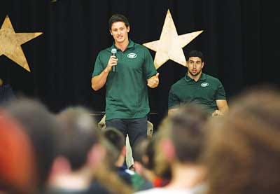 Photo by Tracy Klimek Jets punter Ryan Quigley speaks to Glen Meadow School students while tight end Chris Pantale looks on.