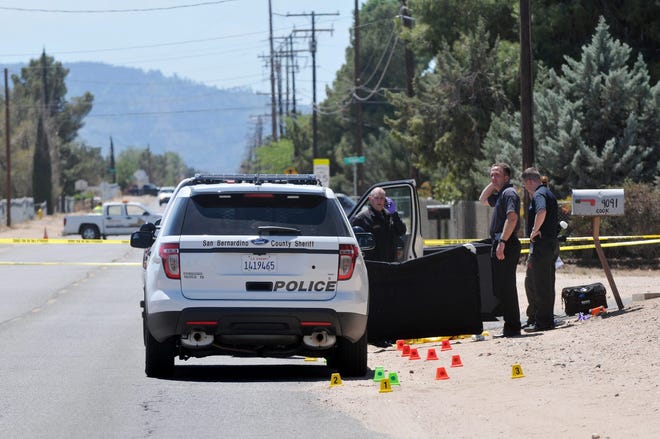 San Bernardino County Sheriff's officials conduct a death investigation on Cottonwood Road, just South of Poplar Street in Hesperia on Sunday. 

David Pardo, Daily Press