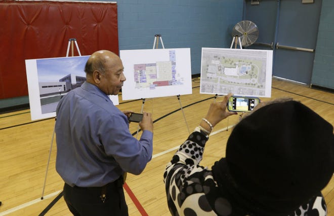 John Coats, vice president of the Driving Park Civic Association, and his wife Renee take photos of the renovation plans for the Driving Park Recreation Center before a press conference to unveil the city's 2015 Capital Improvements Budget in this March 18, 2015, file photo.