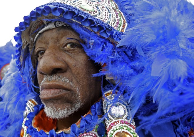 Walter Big Chief, of the Black Mohawk Mardi Gras Indians, parades with the group at the Jazz and Heritage Festival in New Orleans, Friday, April 24, 2015. (AP Photo/Gerald Herbert)