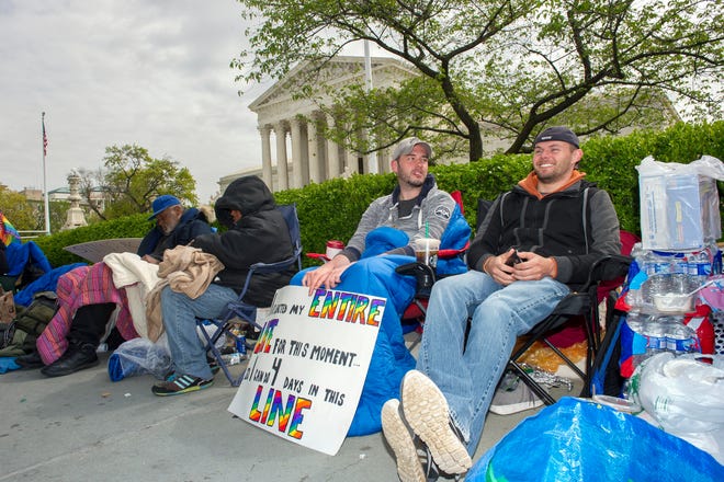 Sean Varsho, 28, of Chicago, left, and Brandon Dawson, 26, of Warrenton Va., have been waiting in line for the past three days for a seat for Tuesday's Supreme Court hearing on gay marriage in Washington.
