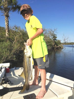 Tanner Malphurs, 10, from Flagler Beach, caught this 31.6-inch snook fishng with his father Wade Malphurs in the Highbridge area on a recent river outing.