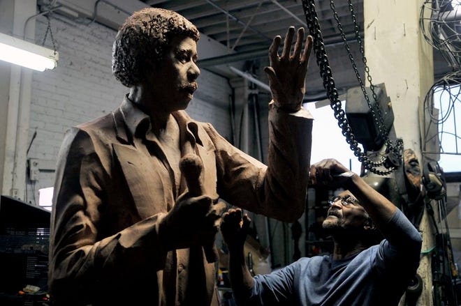 In this Journal Star file photo, Peoria artist Preston Jackson uses a butter knife to work on the small details of his oil-based clay model statue of comedian Richard Pryor at Jackson's studio in the Contemporary Art Center building.