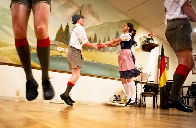 In this Journal Star file photo from May 7, 2012, Metamora Township High School senior Michael Crotteau, left, and fellow classmate Julia Roos hold hands and jump as they perform a traditional German dance for Maifest attendees at The Lindenhof in Peoria.