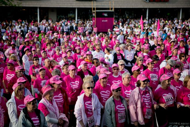 Breast cancer survivors gather for a song, words of encouragement and speeches during the survivors ceremony at the 29th annual Race for the Cure at the Metro Centre.