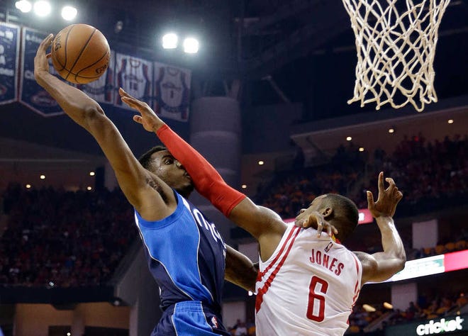 Dallas Mavericks' Al-Farouq Aminu (7) is fouled by Houston Rockets' Terrence Jones (6) during the first half of Game 5 in the first round of the NBA basketball playoffs Tuesday, April 28, 2015, in Houston. (AP Photo/David J. Phillip)