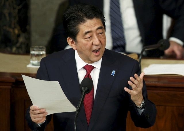 Japanese Prime Minister Shinzo Abe hoolds his text as he addresses a joint meeting of the U.S. Congress on Capitol Hill in Washington, April 29, 2015. REUTERS/Gary Cameron