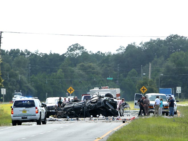 In this July 23, 2014 file photo, officials pick up the body of David Anthony Newmeyer, 17, at the scene of a stolen vehicle crash on US 19 and CR 55A in Cross City.