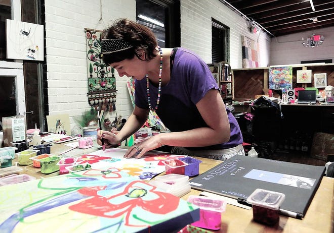 Artist Sarah Dugger works on some of her art in the Mr. McGillicutty Art Studio in Dover recently.