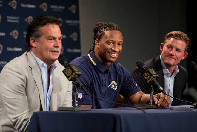 St. Louis Rams head coach Jeff Fisher, left, and General Manager Les Snead, right, introduce first-round draft pick Todd Gurley during a news conference at the NFL football team's practice facility Friday, May 1, 2015, in St. Louis. Gurley, a running back from Georgia, was picked tenth overall by the Rams.