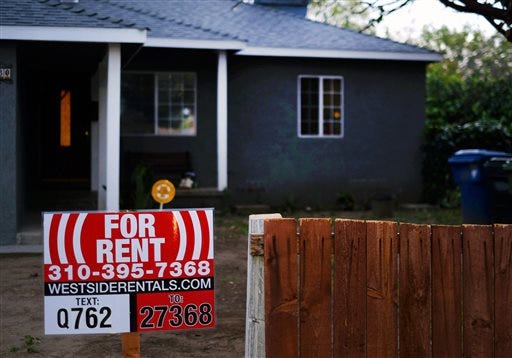This Friday, Feb. 27, 2015, photo shows a sign advertising a house for rent in Los Angeles. More than one-in-four renters must devote at least half of their family income to housing and utilities, according to a new analysis of Census data by Enterprise Community Partners, a nonprofit that helps finance affordable housing. (AP Photo/Richard Vogel)