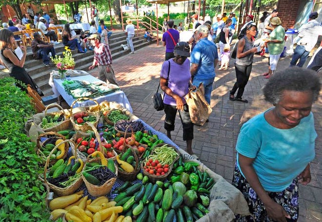 Area residents check out the plentiful bounty of a recent harvest during a market garden celebration at the West Broad Market Garden in Athens, Ga. on Thursday, June 28, 2012.  Richard Hamm/Staff (OnlineAthens/Athens Banner-Herald)