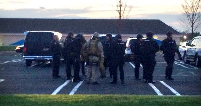 Montgomery County SWAT team members suit up in Assi Plaza shopping center in Montgomery Township Thursday, April 30, 2015, due to police activity nearby.
