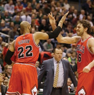 Chicago Bulls’ Paul Gasol, right, and Taj Gibson react to Gibson's basket against the Milwaukee Bucks during the first half of Game 6 of an NBA basketball first-round playoff series Thursday in Milwaukee.