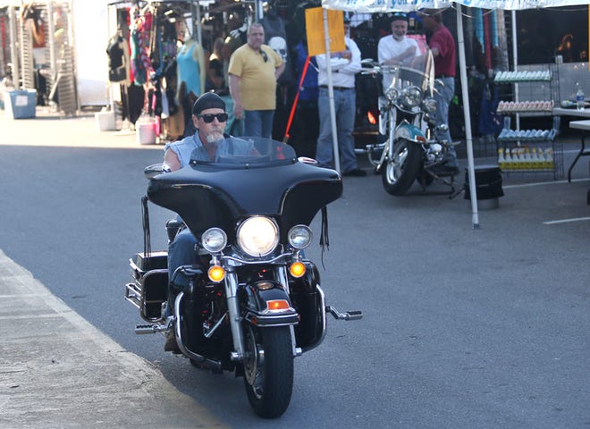 A biker reads through the Vendor Village at the Boardwalk Beach resort. Thunder Beach kicked off in Panama City Beach on April 29. Vendor Villages open again today at 9 a.m. at Frank Brown Park, Boardwalk Beach Resort, Sharky’s Beach Club, Shoppes at Edgewater, Club La Vela and Harley-Davidson of Panama City Beach.