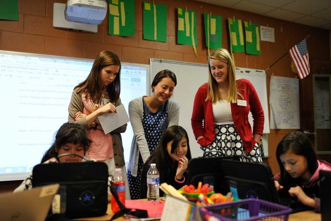 University of Georgia early childhood education students Abbey Rikard, from left, Madison Yancey and Kenzie Winther watch as Rubi Abarca, from left, Maritza Mondragon-Pedraza and Jinnellie Gonzalez work on Tuesday, April 7, 2015, at J.J. Harris Elementary School in Athens, Ga. (AJ Reynolds/Staff)