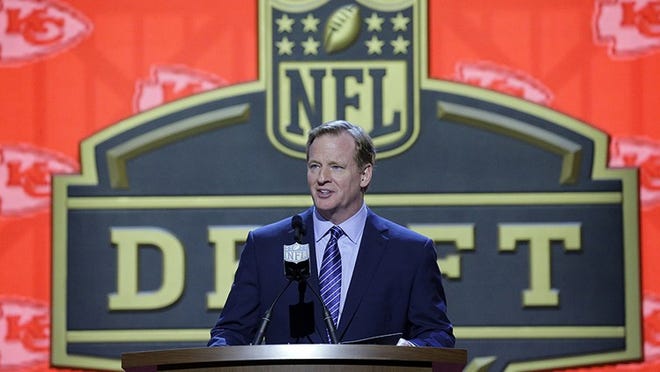 NFL commissioner Roger Goodell announces after the Kansas City Chiefs selects Washington defensive back Marcus Peters as the 18th pick in the first round of the 2015 NFL Football Draft, Thursday, April 30, 2015, in Chicago. (AP Photo/Nam Y. Huh)