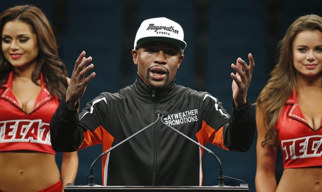 Floyd Mayweather Jr. gestures during a press conference following his welterweight title fight on Saturday, May 2, 2015 in Las Vegas. Mayweather defeated Manny Pacquiao in a unanimous decision. (AP Photo/John Locher)