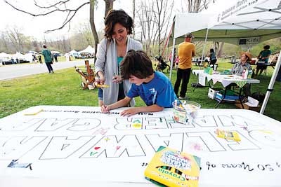 Drew Huffman, 7, and his mother, Amanda, of Andover, draw on a "Delaware Water Gap" banner.