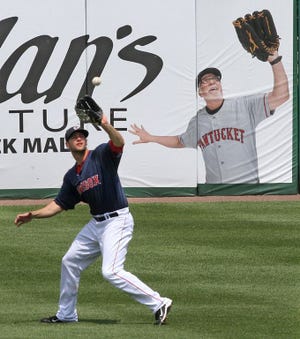Alex Hassan fields a fly ball at McCoy Stadium in 2014.