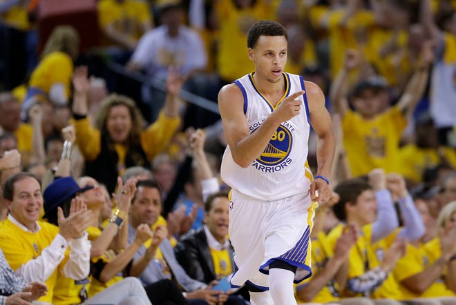 Golden State's Stephen Curry reacts after scoring against Memphis in the first half of Sunday's win.