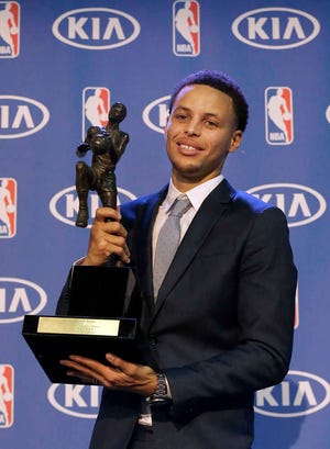 Golden State Warriors point guard Stephen Curry holds the NBA's Most Valuable Player award on Monday.